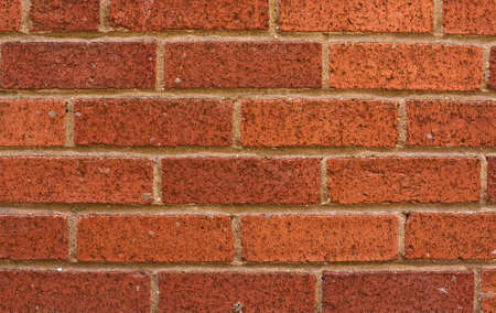 Red, orange, brick wall textured background with honeycombs, closeupの写真素材