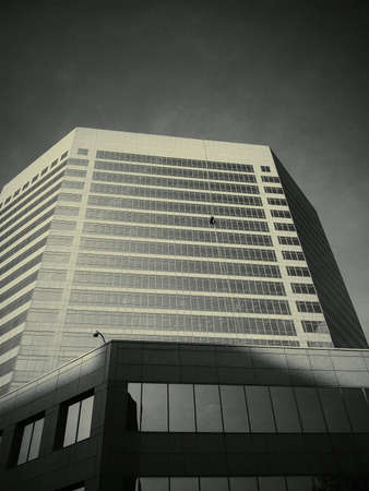 Snall window cleaner on a large building