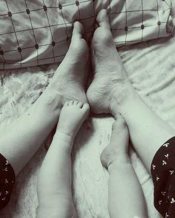Mother and baby feet together one in one