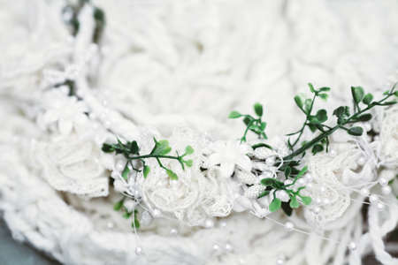 Beautiful soft tender retro vintage fabric woolen cloth chaplet with laces, artificial flowers, leaves, small beads, wedding decoration, card with copyspace for textの写真素材