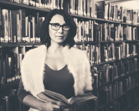 Black and white retro vintage toned portrait of middle age mature Caucasian woman student with...