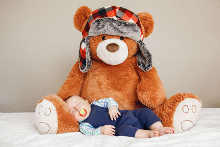Portrait of a cute adorable white Caucasian baby newborn boy sleeping dreaming with pacifier soother...