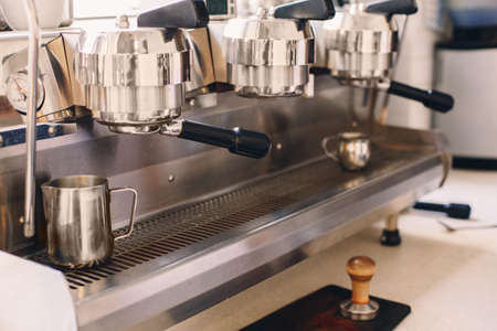 Professional coffee maker. Interior of coffee shop. Closeup of coffee machine in cafe. Toned with...
