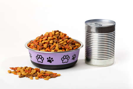 Colorful dry cat dog food in granules in cute bowl isolated on white background. Canned pet food. Variety of domestic animal meal.の写真素材