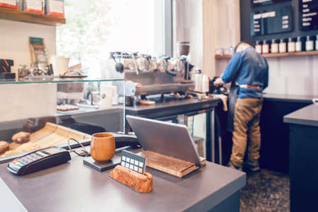 Interior design details of empty modern coffee shop restaurant at daytime with natural light. Small local business. Environment workplace of food drink server cashier.の写真素材