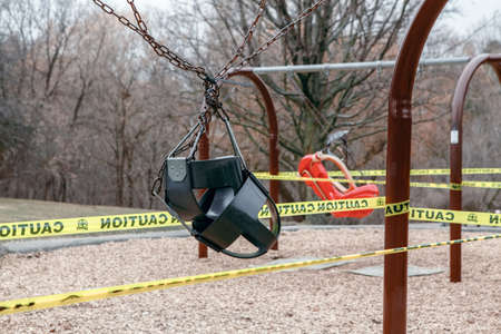 Toronto, Ontario, Canada - March 26, 2020: Closed outdoor playground. Kids play area locked with yellow caution tape to stop people gathering. Coronavirus social distance quarantine.のeditorial素材