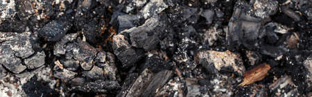 Natural ash charcoal fire place texture background. Closeup macro of burnt wood tree log. Dirty...