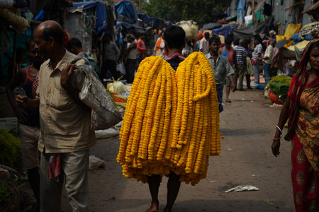 9th June 2022 in MULLICK GHAT, Kolkata, West Bengal, India. Garland Made with Marigold Carried in Some interesting Way for Sellingのeditorial素材