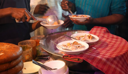 Serving Dahi Vada at Zakaria Street During Eid al-Fitr Near Nakhoda Masjidの写真素材