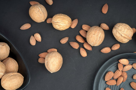 Almonds and walnut flat lay shoot in black backgroundの写真素材