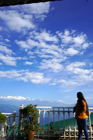 Young Woman Looks Out at Himalayas and Kanchenjunga Peaksの写真素材