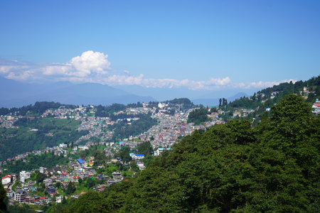 Panoramic aerial view of Darjeeling town nestled in the green Himalayan mountains under a clear blue...