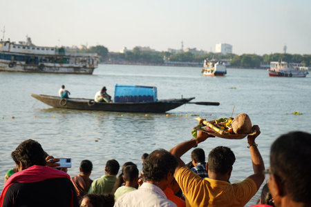 19th November 2023, Kolkata, West Bengal, India. Hindu devotee holding traditional prayer offerings...