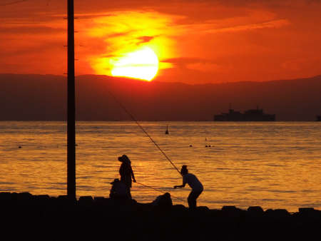 fishermen in a twilightの写真素材