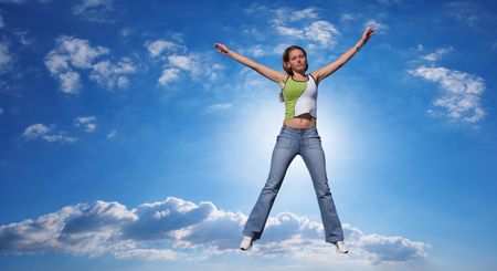 The jump of the girl is higher than cloudsの写真素材