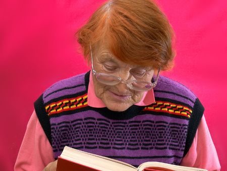 In a photo it is shown as the grandmother reads the bookの写真素材