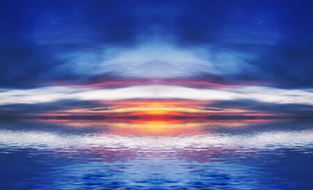 The quiet sea on a background of a beautiful sunset with the moon and starsの写真素材