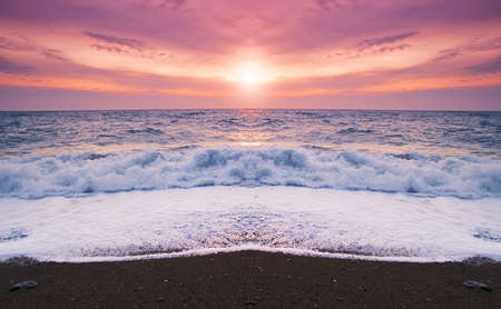sunset on a background of the storm seaの写真素材