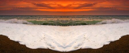 sunset on a background of the storm seaの写真素材