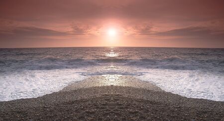 sunset on a background of the storm seaの写真素材