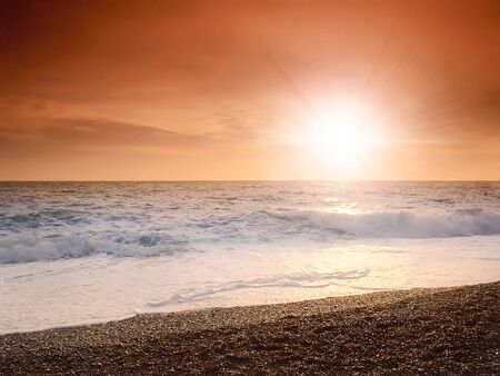 sunset on a background of the storm sea  の写真素材