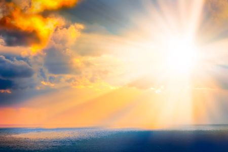 Through clouds on the sea light flows の写真素材