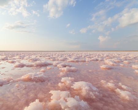 pink salt lake on the background of beautiful cloudsの写真素材