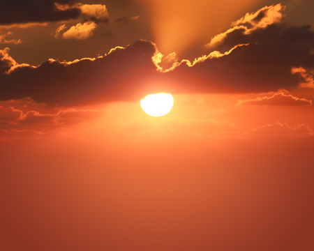 red sunset with clouds photographed by a telephoto lensの写真素材