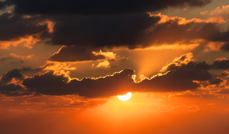 red sunset with clouds photographed by a telephoto lensの写真素材