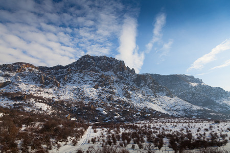 Winter scenery with mountains and a clouds.の写真素材