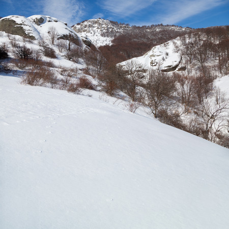 Winter scenery with mountains and a clouds.の写真素材