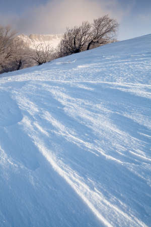 Winter scenery with mountains and a clouds.の写真素材