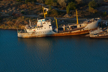 Rusty ships on the sea near the coast.の写真素材