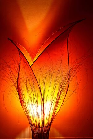 Creative lamp looking an orange tulip ligths up the room with yellow, orange and red colorsの写真素材