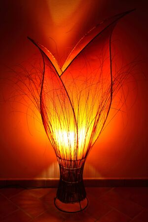 Creative lamp looking an orange tulip ligths up the room with yellow, orange and red colorsの写真素材