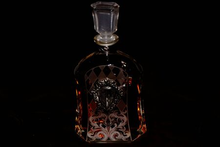 Elegant bottle of whiskey with decorated glass in the black backgroundの写真素材