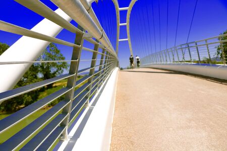 Getting out lockdown - People cycling across a bridge on a bicycle path in Spring - Maremma Regional Park - Tuscany - Italyの写真素材