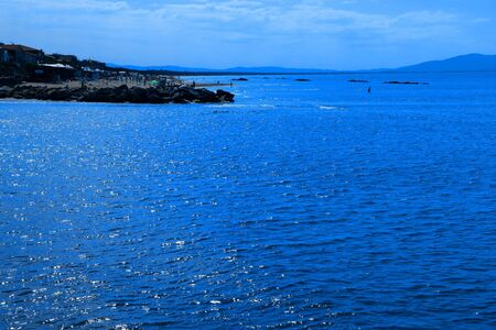 People relaxing by seaside in a tourist location - Castiglione della Pescaia - Tuscany - Italyの写真素材