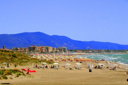 People relaxing by seaside in a beach close a tourist location - Marina di Grosseto - Tuscany - Italyの写真素材