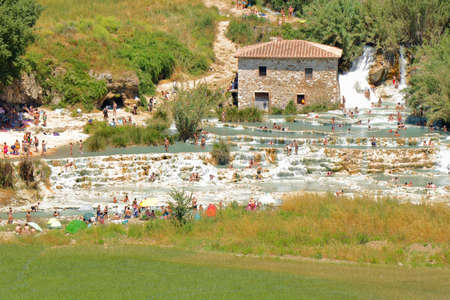 People having a bath and relaxing with natural hot springs in the open - Saturnia - Tuscany - Italyの写真素材