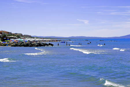 People relaxing by seaside in a tourist location - Castiglione della Pescaia - Tuscany - Italyの写真素材