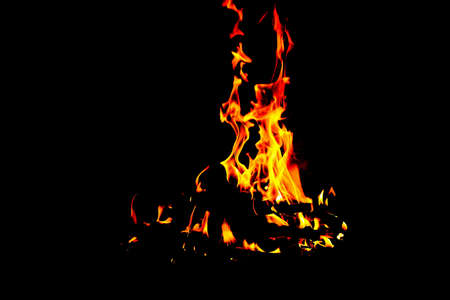 High flame of wood fire into a fireplace in a cold winterの写真素材