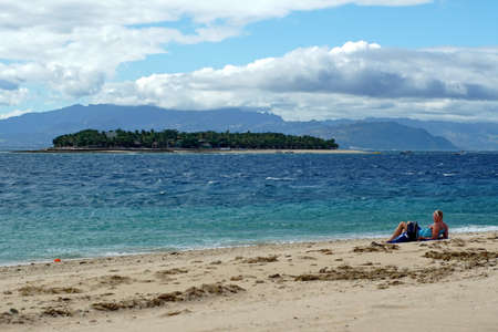Tourist sunbathing on the beach in Fijiのeditorial素材