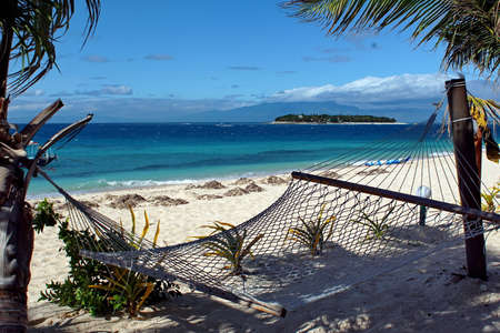 Hammock on the beach at a resort in Fijiの写真素材