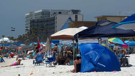 Crowd with colorful umbrellas on Panama City Beach, Florida, USA, shortly after the beach reopened following COVID-19 closuresのeditorial素材