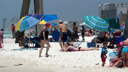 Crowd with colorful umbrellas on Panama City Beach, Florida, USA, shortly after the beach reopened following COVID-19 closuresのeditorial素材