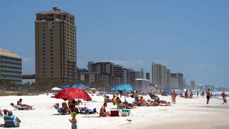 Crowd with colorful umbrellas on Panama City Beach, Florida, USA, shortly after the beach reopened following COVID-19 closuresのeditorial素材