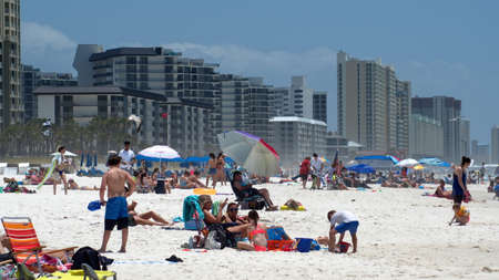 Crowd with colorful umbrellas on Panama City Beach, Florida, USA, shortly after the beach reopened following COVID-19 closuresのeditorial素材