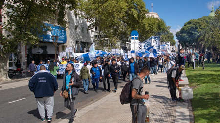 People marching with blue and white banners and umbrellas on the Day of Remembrance in Buenos Aires, Argentinaのeditorial素材