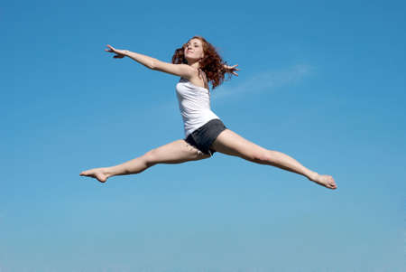 The happy young Girl on Outdoors. A series Unusual jump 